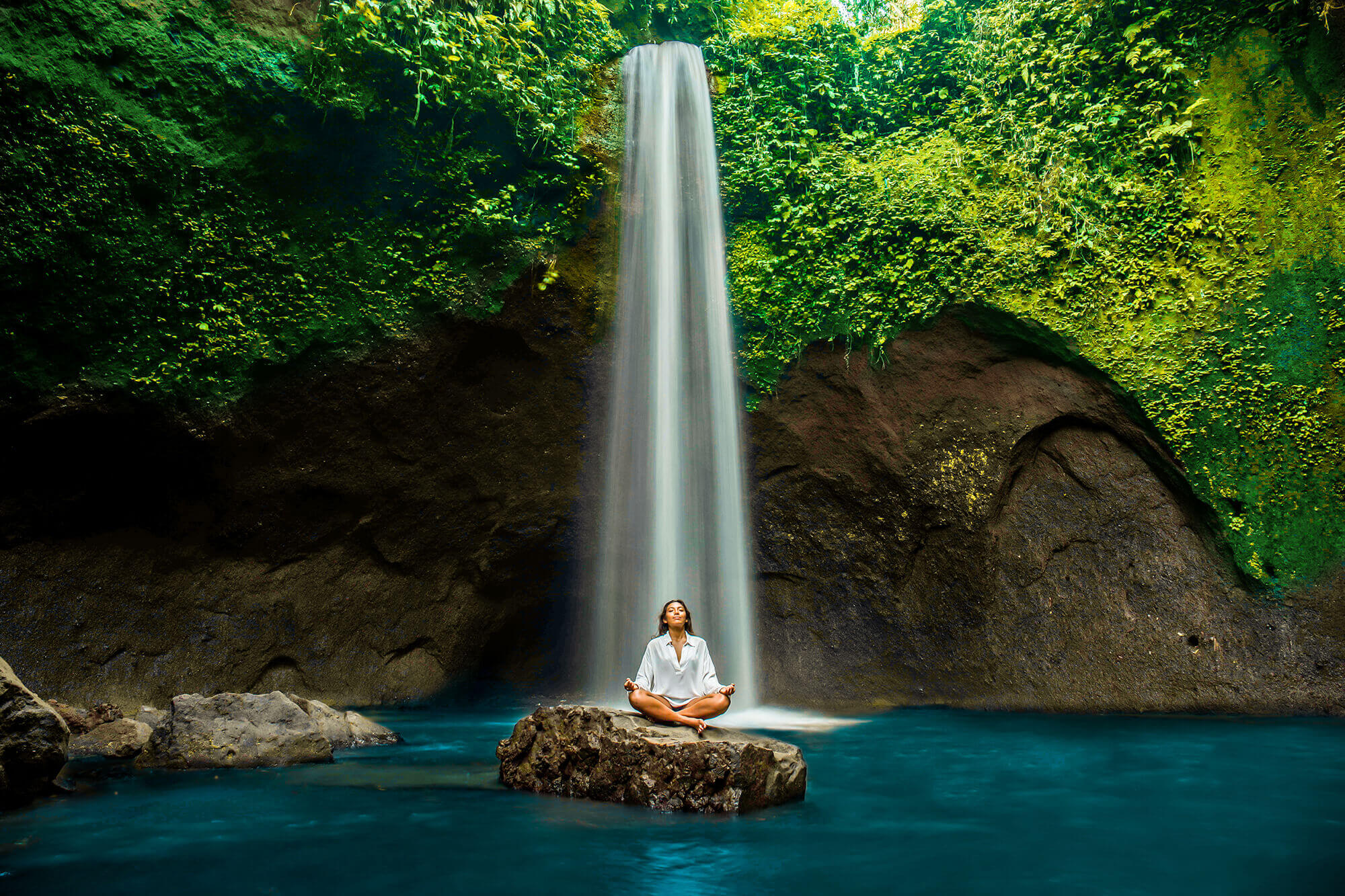 Meditative moment by a waterfall